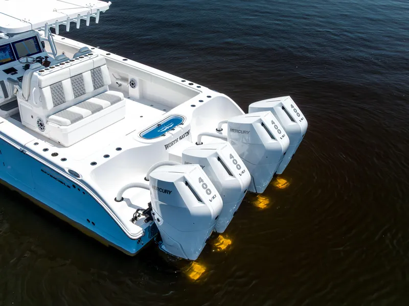Slide: The Image of 2024 Invincible 37 Catamaran with four Mercury engines, featuring a spacious deck and modern controls. - 20
