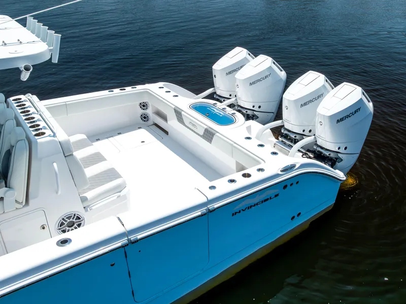 Slide: The Image of 2024 Invincible 37 Catamaran with four Mercury outboard engines on calm water. - 21