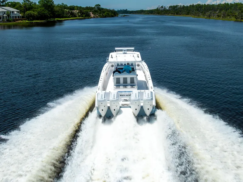 Slide: The Image of 2024 Invincible 37 Catamaran cruising on a scenic river. - 22