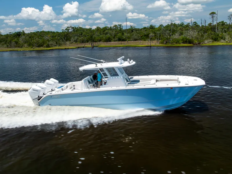 Slide: The Image of 2024 Invincible 37 Catamaran cruising on a scenic waterway under a clear sky. - 25