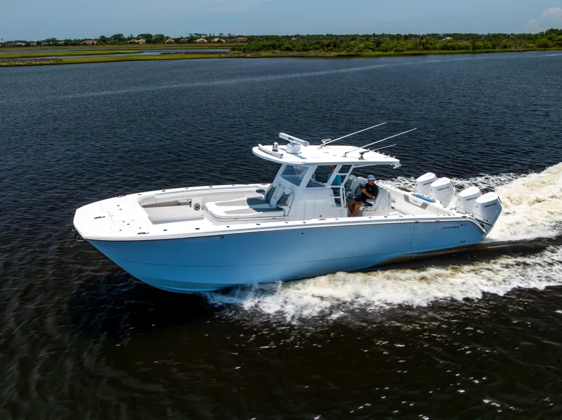 Slide: The Image of 2024 Invincible 37 Catamaran cruising on a calm river, showcasing sleek design and powerful engines. - 27