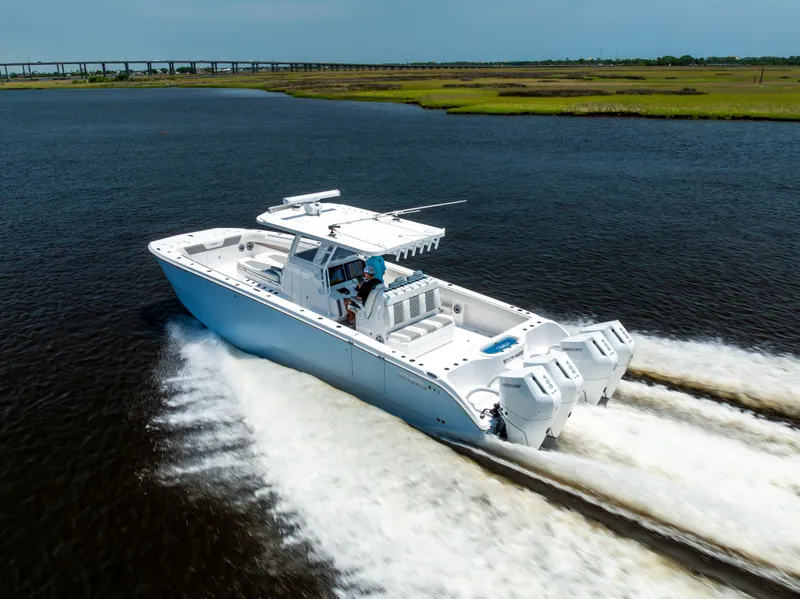 Slide: The Image of 2024 Invincible 37 Catamaran cruising on open water, showcasing sleek design and powerful engines. - 29