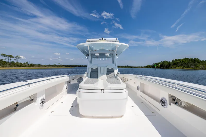 Slide: The Image of 2024 Invincible 37 Catamaran on calm water, showcasing sleek design and spacious deck. - 33