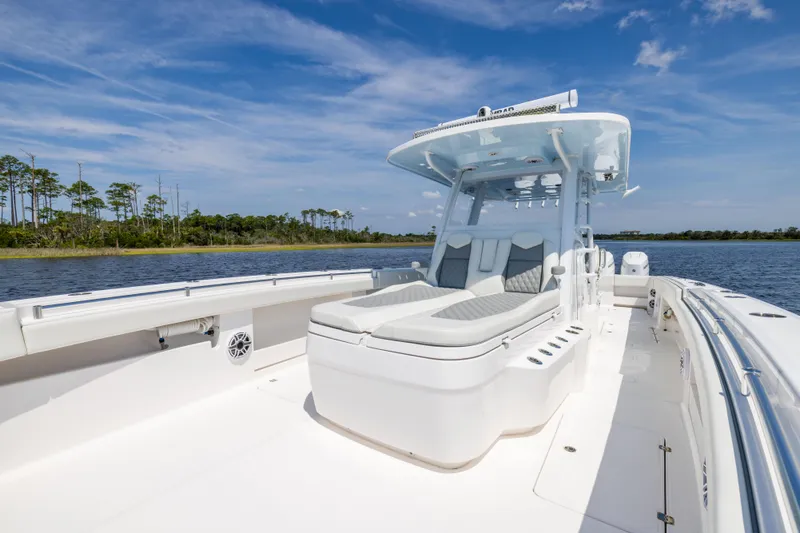 Slide: The Image of 2024 Invincible 37 Catamaran on calm water, featuring spacious deck and modern seating. - 35