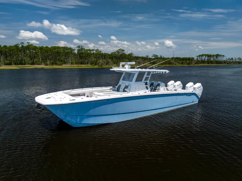 Slide: The Image of 2024 Invincible 37 Catamaran on calm water, showcasing sleek design and powerful engines. - 4