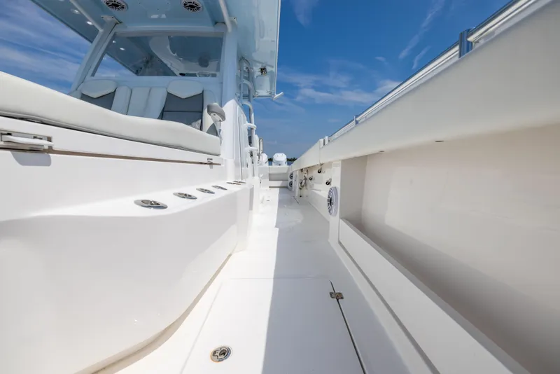 Slide: The Image of 2024 Invincible 37 Catamaran deck with sleek seating and modern design under a clear blue sky. - 42