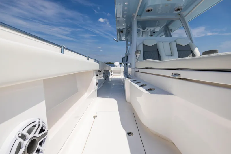 Slide: The Image of 2024 Invincible 37 Catamaran interior with sleek seating and modern design under a clear sky. - 43