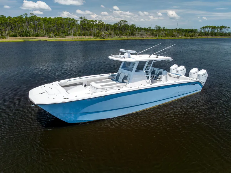 Slide: The Image of 2024 Invincible 37 Catamaran on calm water, showcasing sleek design and powerful engines. - 5