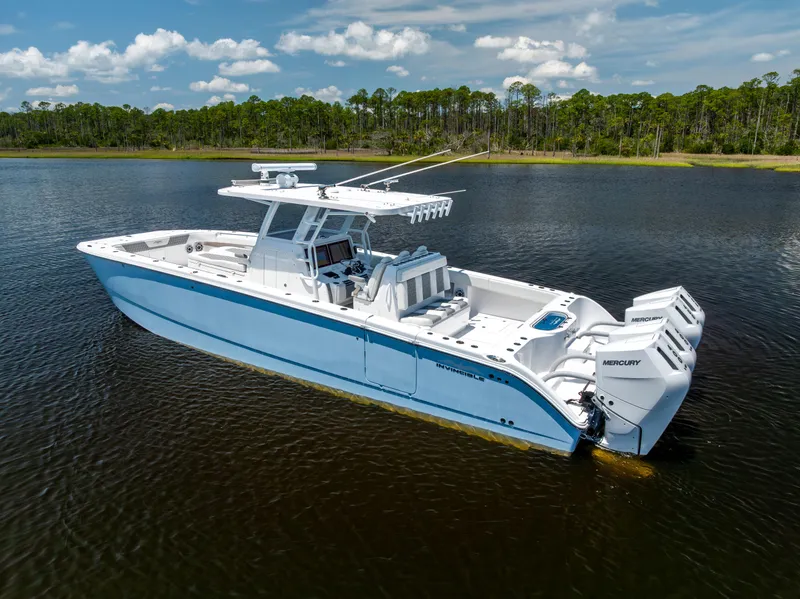 Slide: The Image of 2024 Invincible 37 Catamaran on calm water, featuring sleek design and powerful Mercury engines. - 6