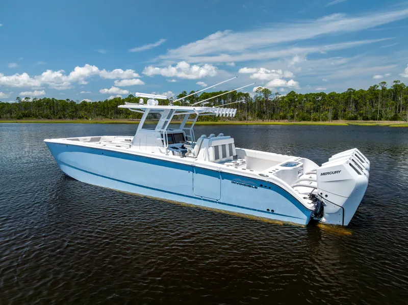 Slide: The Image of 2024 Invincible 37 Catamaran on calm water, showcasing sleek design and powerful engines. - 7