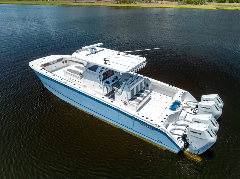 Slide: The Image of 2024 Invincible 37 Catamaran with triple Mercury engines on calm water. - 8