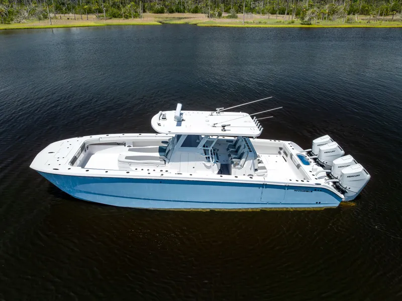 Slide: The Image of 2024 Invincible 37 Catamaran on calm water, showcasing sleek design and powerful engines. - 9