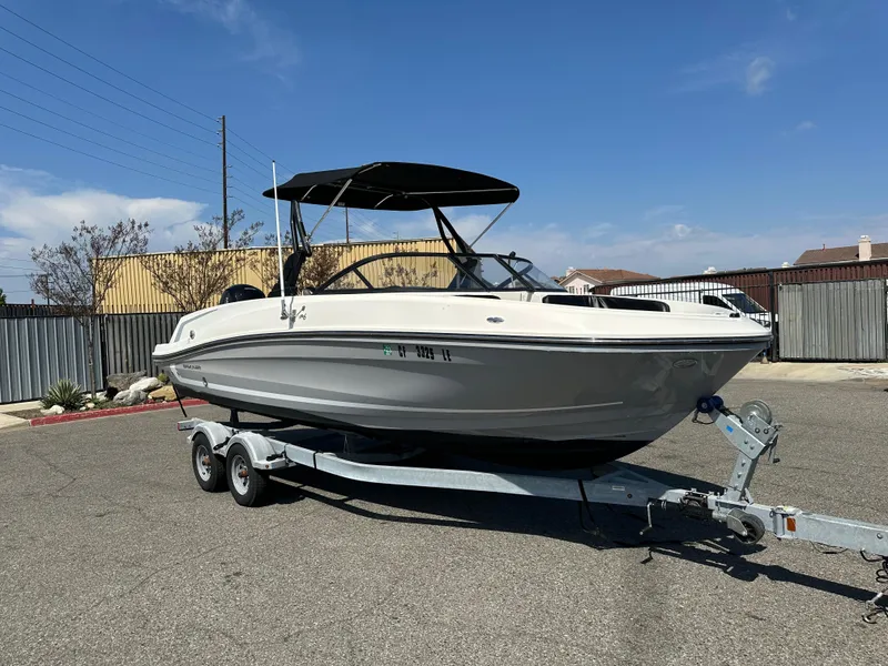 The Image of 2020 Bayliner VR6 Bowrider OB on trailer in parking lot. - 0