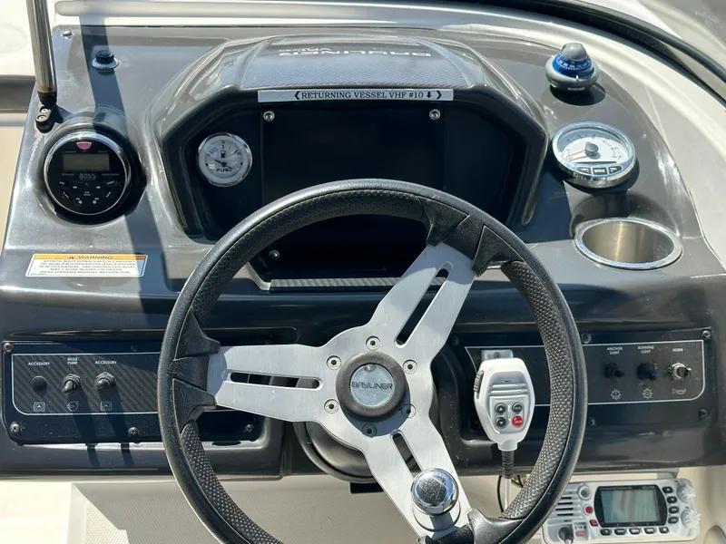 Slide: The Image of 2020 Bayliner VR6 Bowrider OB dashboard with steering wheel and control panel. - 12