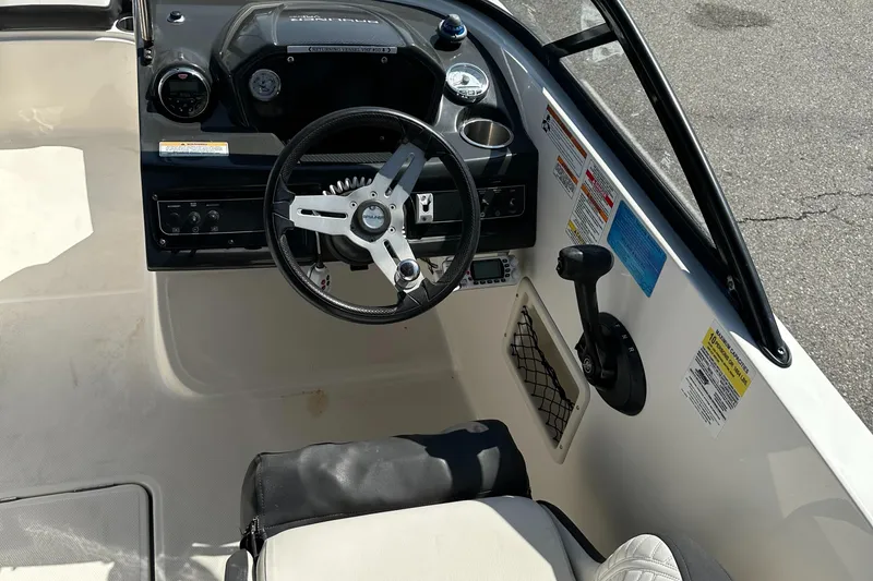 Slide: The Image of 2020 Bayliner VR6 Bowrider OB cockpit with steering wheel and control panel. - 13