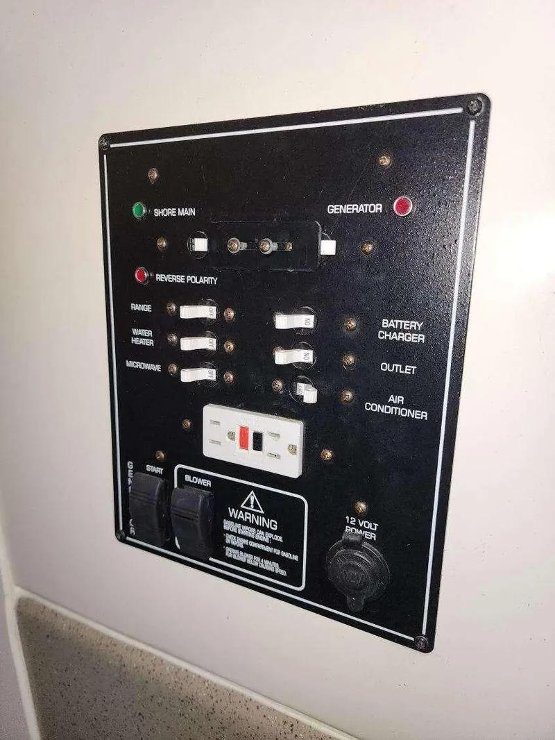 Slide: The Image of Electrical control panel on a 2000 Rinker 270 Express Cruiser boat. - 12