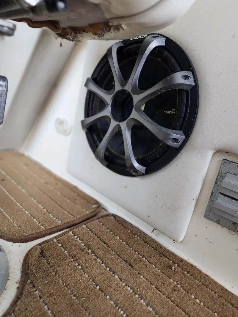 Slide: The Image of Speaker on 2000 Rinker 270 Express Cruiser with beige carpeted flooring. - 17