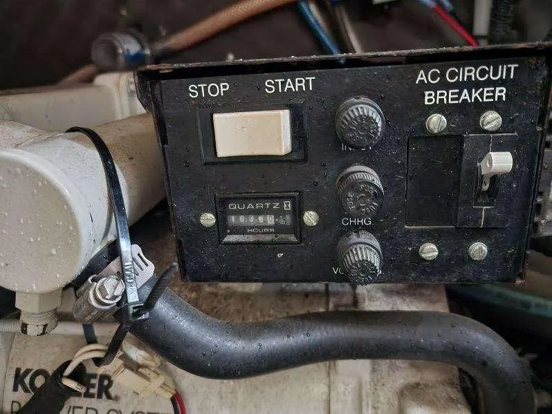 Slide: The Image of Control panel of a 2000 Rinker 270 Express Cruiser with start, stop, and AC circuit breaker. - 19