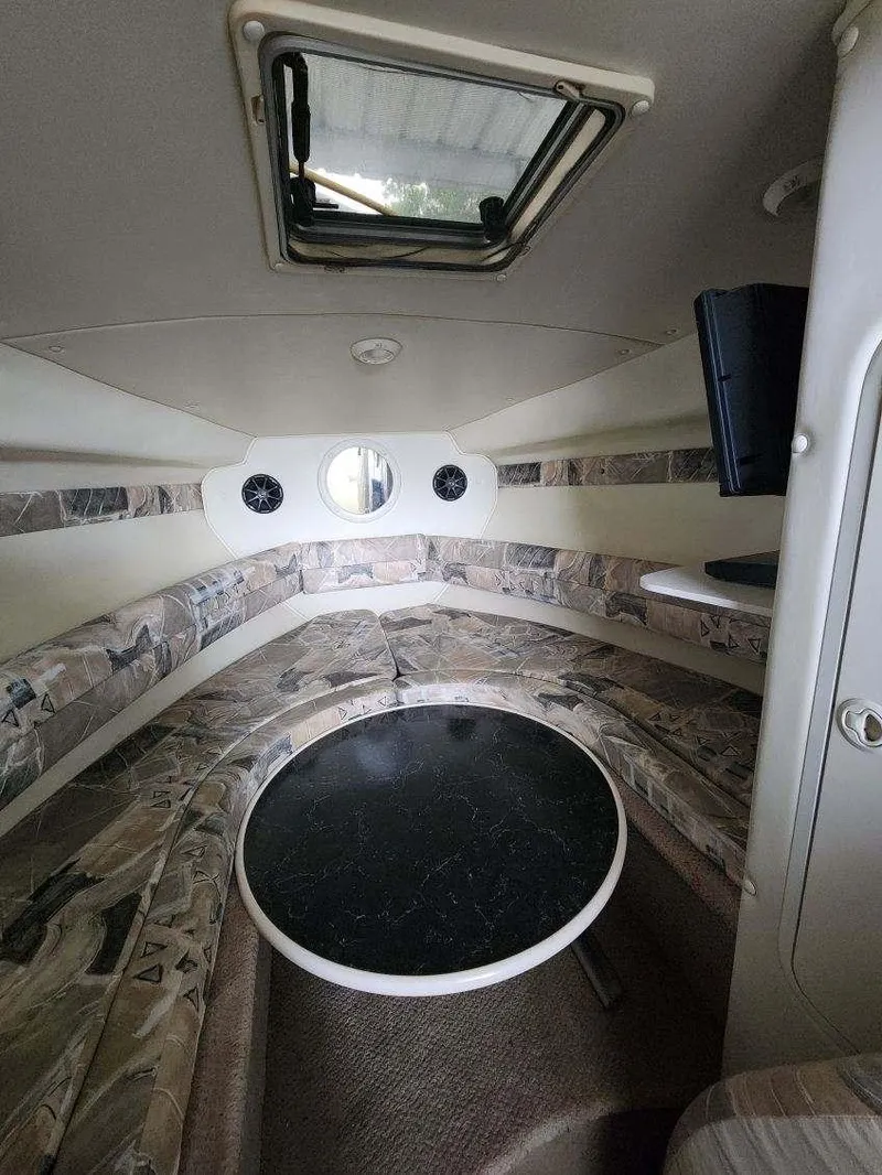 Slide: The Image of Interior of 2000 Rinker 270 Express Cruiser with circular seating and table. - 2