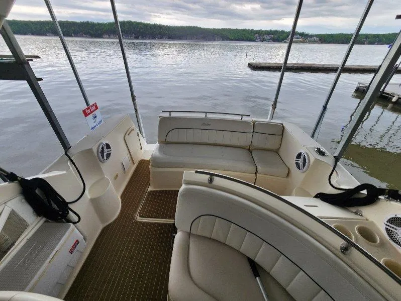 Slide: The Image of 2000 Rinker 270 Express Cruiser interior with lake view, featuring comfortable seating and modern design. - 22
