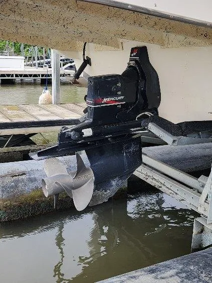 Slide: The Image of Outboard motor of 2000 Rinker 270 Express Cruiser docked by the water. - 27