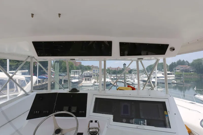Slide: The Image of Interior view of 1991 Viking 50 Convertible yacht cockpit with marina background. - 10