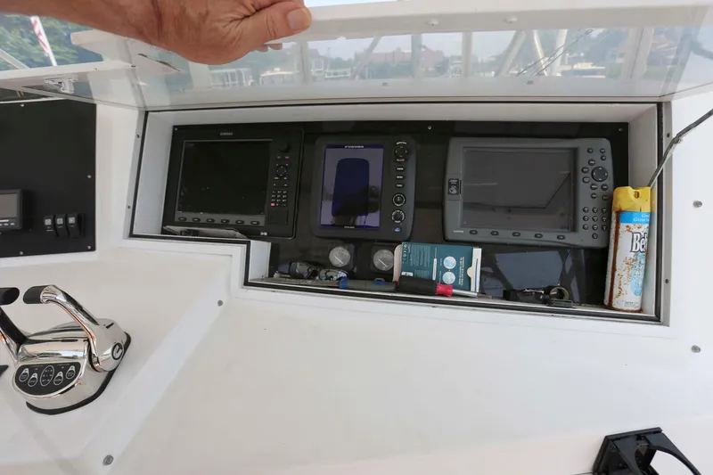 Slide: The Image of 1991 Viking 50 Convertible boat dashboard with navigation equipment and controls. - 11