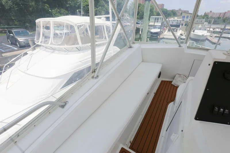 Slide: The Image of 1991 Viking 50 Convertible yacht interior with white seating and wood flooring. - 12