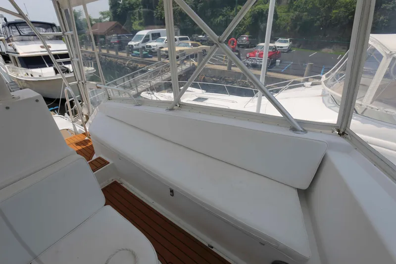 Slide: The Image of 1991 Viking 50 Convertible yacht interior with white seating and wooden flooring. - 13