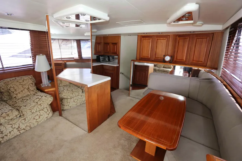 Slide: The Image of Luxurious interior of 1991 Viking 50 Convertible yacht with wood accents and plush seating. - 19