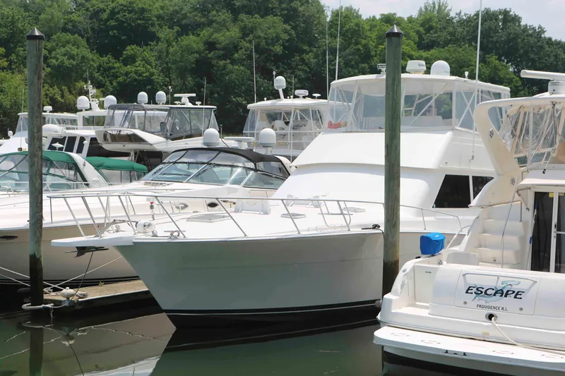 Slide: The Image of Docked 1991 Viking 50 Convertible yacht among other boats in a marina. - 2