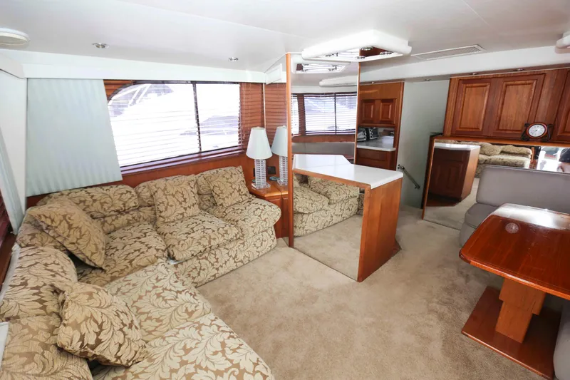 Slide: The Image of Luxurious interior of 1991 Viking 50 Convertible yacht with plush seating and wooden accents. - 20
