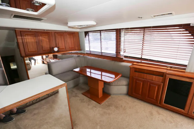 Slide: The Image of Interior of 1991 Viking 50 Convertible yacht with wood cabinetry and plush seating. - 21