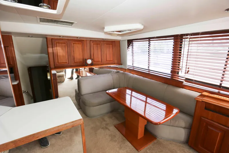Slide: The Image of Luxurious interior of 1991 Viking 50 Convertible yacht with wooden accents and plush seating. - 22