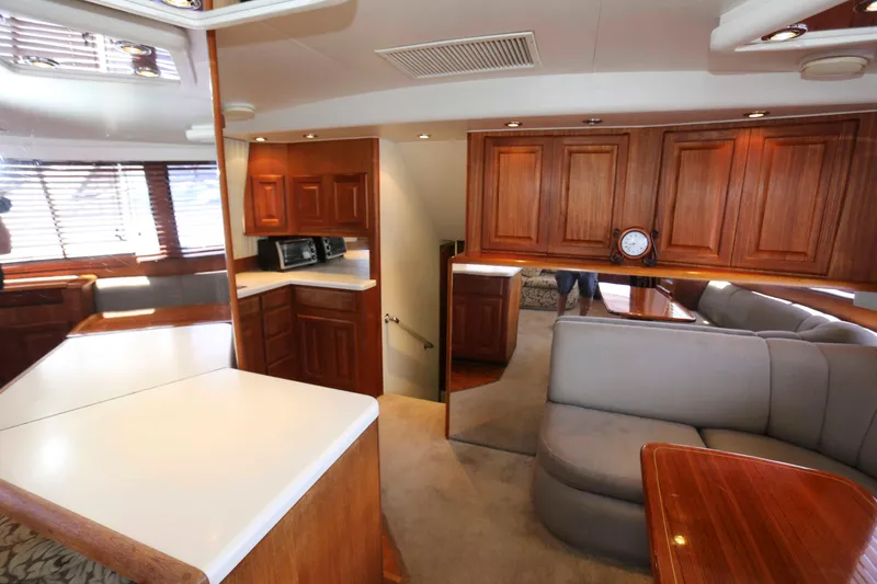 Slide: The Image of Interior of 1991 Viking 50 Convertible yacht with wood cabinetry and seating area. - 24