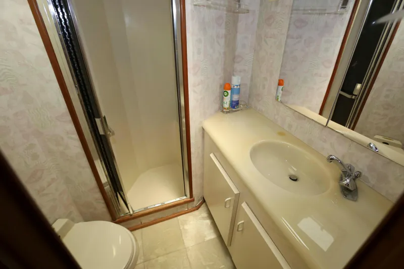 Slide: The Image of Bathroom interior of 1991 Viking 50 Convertible yacht with shower, sink, and toilet. - 29