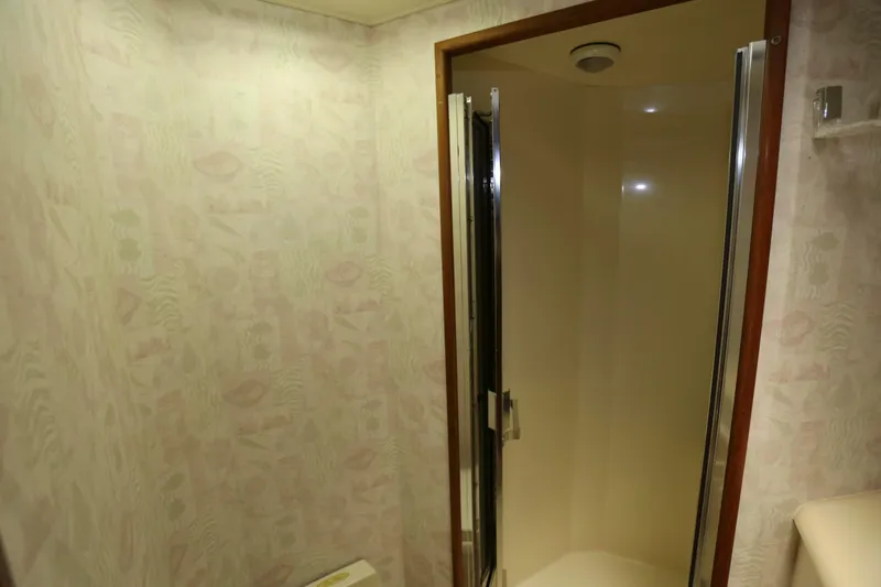 Slide: The Image of Shower area in 1991 Viking 50 Convertible yacht with patterned wallpaper. - 30