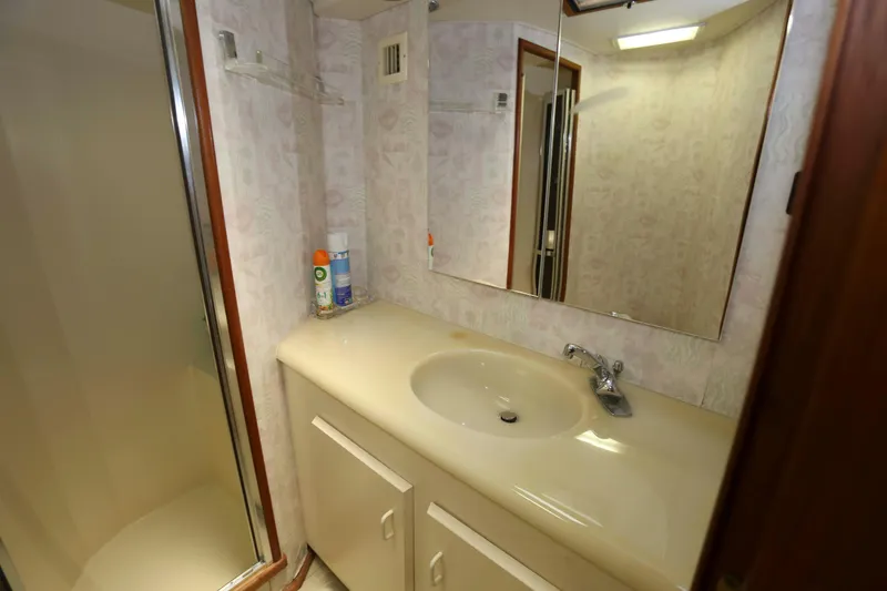 Slide: The Image of Bathroom interior of 1991 Viking 50 Convertible yacht with sink and shower. - 31
