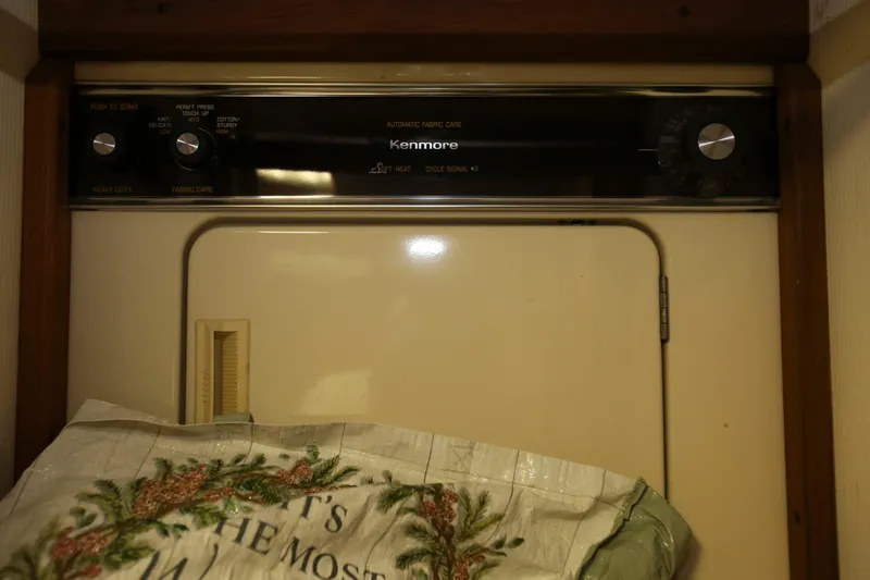 Slide: The Image of Kenmore dryer control panel with fabric care settings, partially covered by a decorative cloth. - 36