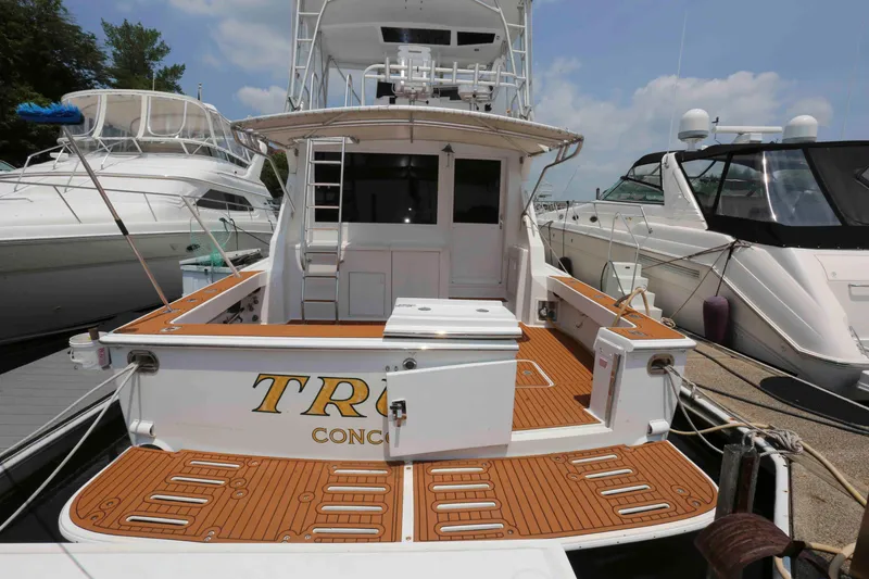 Slide: The Image of 1991 Viking 50 Convertible yacht docked, featuring spacious deck and sleek design. - 4