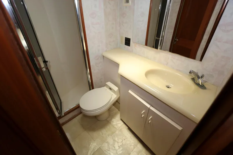 Slide: The Image of Bathroom interior of 1991 Viking 50 Convertible yacht, featuring shower, toilet, and sink. - 40