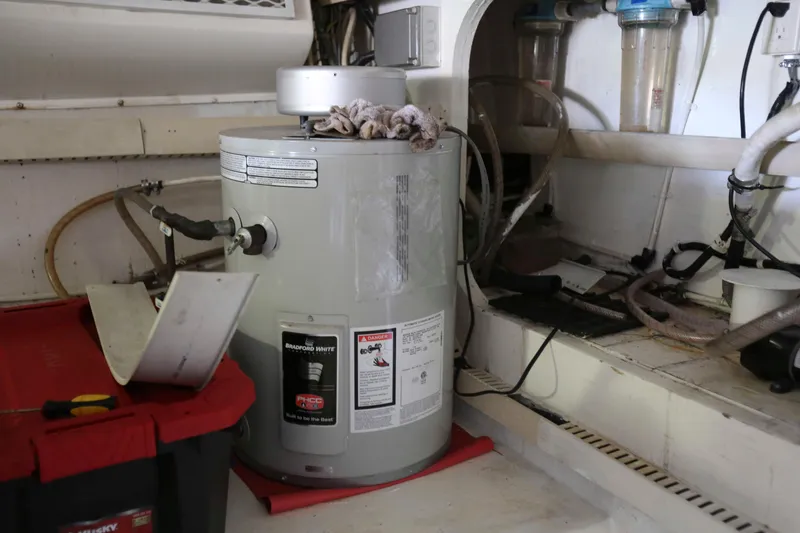 Slide: The Image of Engine room of 1991 Viking 50 Convertible with water heater and storage. - 47