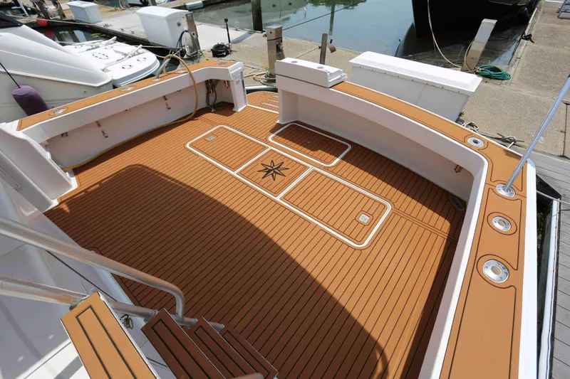 Slide: The Image of 1991 Viking 50 Convertible boat deck with teak flooring at marina. - 6