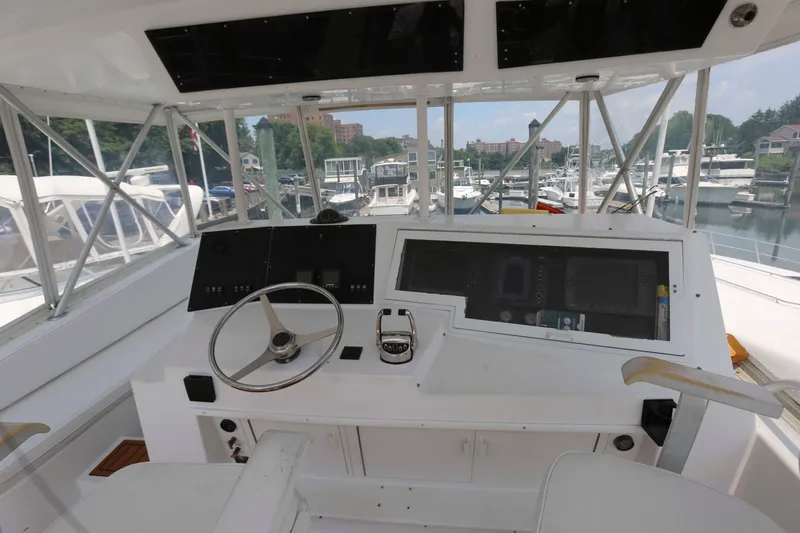 Slide: The Image of Cockpit of 1991 Viking 50 Convertible yacht with steering wheel and control panel. - 9