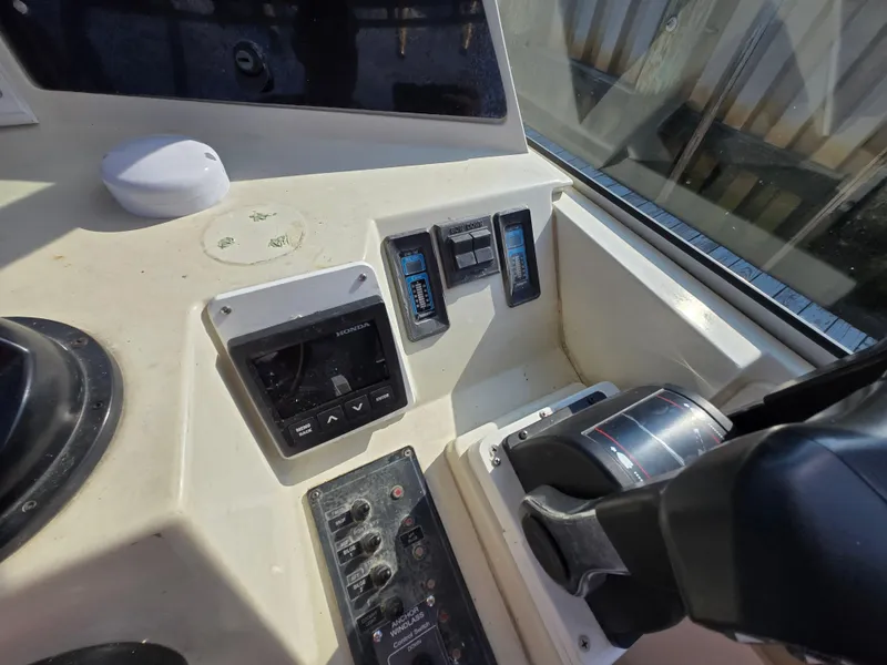 Slide: The Image of 1996 Stratos 2500 Walkaround boat dashboard with controls and gauges. - 7