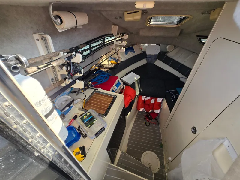 Slide: The Image of Interior of a 1996 Stratos 2500 Walkaround boat with fishing gear and equipment. - 8