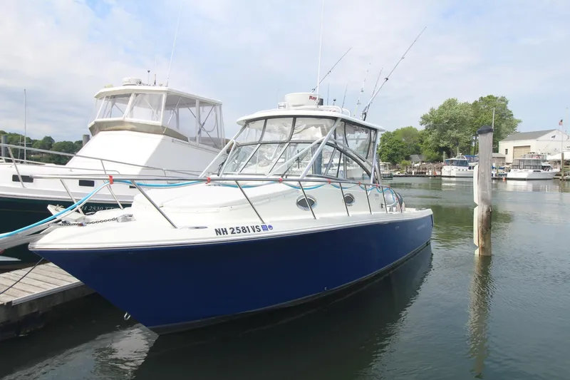 The Image of 2007 Sailfish 3006 WALKAROUND boat docked in a marina, clear sky background. - 0