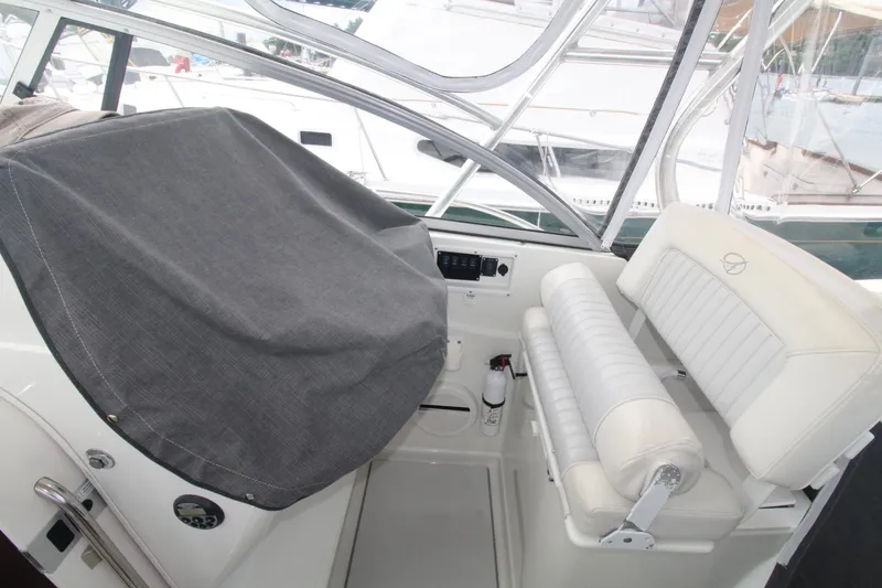 Slide: The Image of 2007 Sailfish 3006 WALKAROUND boat interior with covered console and white seating. - 13