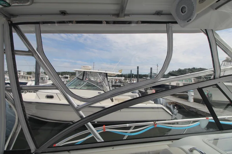 Slide: The Image of 2007 Sailfish 3006 WALKAROUND boat docked at marina, viewed through cabin window. - 16