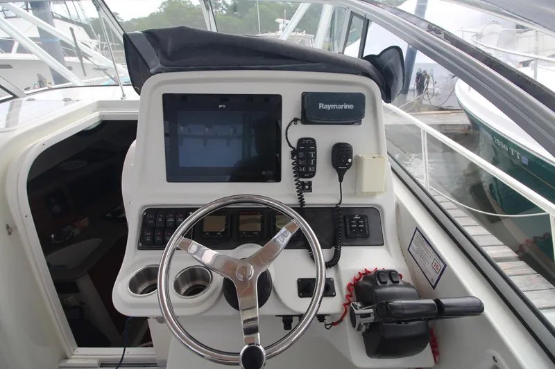 Slide: The Image of 2007 Sailfish 3006 WALKAROUND boat helm with steering wheel and navigation equipment. - 18